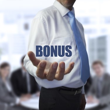Elegant businessman holding the word bonus