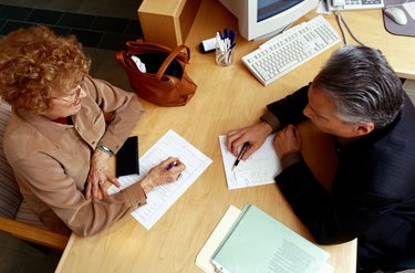 Financial Advisor Assisting Woman with Paperwork