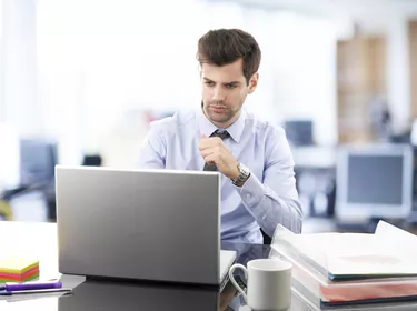 Young businessman working on laptop