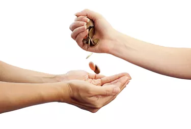 "Female hands holding coins, with clipping path"