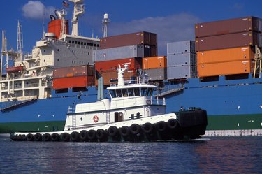 Tugboat Guiding A Giant Barge
