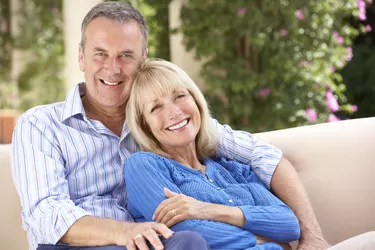 Senior Couple Relaxing On Sofa At Home