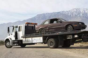 Broken car on tow truck