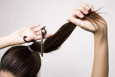 Woman cutting her ponytail