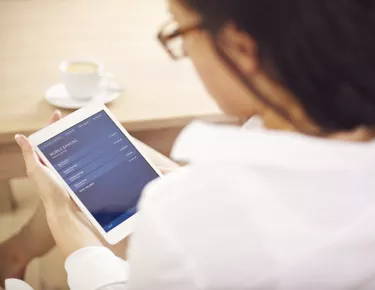 Businesswoman Examining Her Bank Account on Digital Tablet