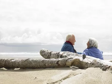 Senior couple sitting on beach