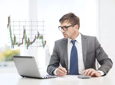 businessman with computer, papers and calculator