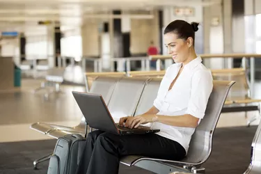 woman using laptop computer at airport