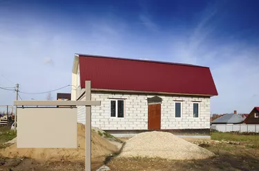 sign on  background of a house under construction