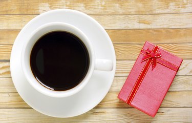 Cup of coffee with red present box