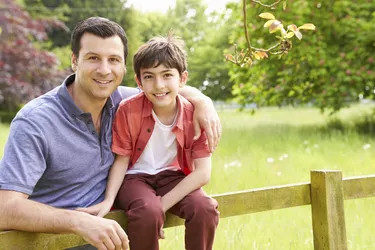 Portrait Of Hispanic Father And Son In Countryside