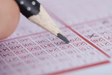 Person Marking Number On Lottery Ticket