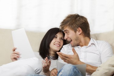 Couple sitting on couch at home