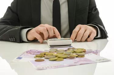 Front view of businessman working in calculator