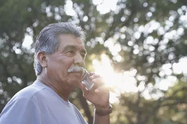 Side profile of a mature man using a mobile phone