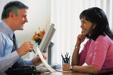 Businessman explaining document to woman