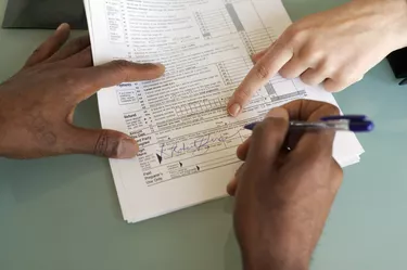Man signing financial paperwork