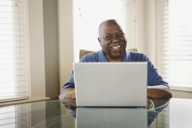 Man using laptop and smiling