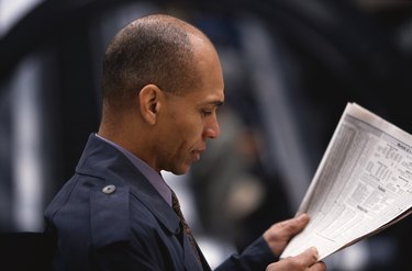 Man Reading the Newspaper Financial Page