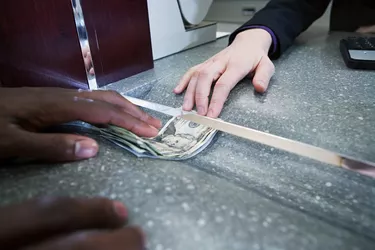 Bank teller giving cash to customer