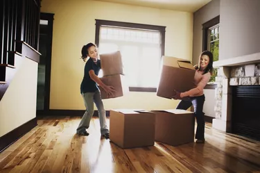 Mother and daughter stacking boxes