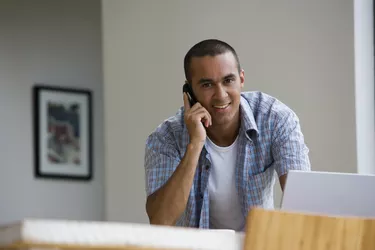 Young man talking on telephone