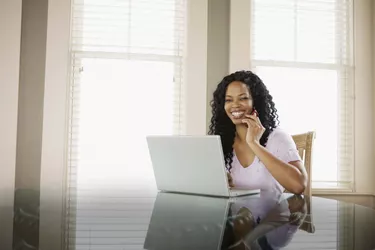 Woman on cell phone and laptop