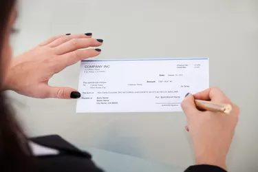 Businesswoman Signing Cheque