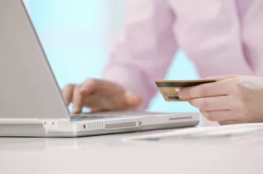 Woman shopping online with laptop computer