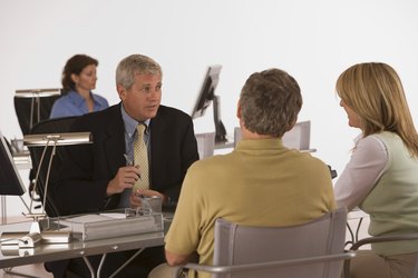Couple talking to a bank manager at a desk