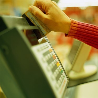 Using credit card in credit card reader, close-up
