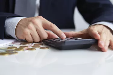 Men's hands with calculator