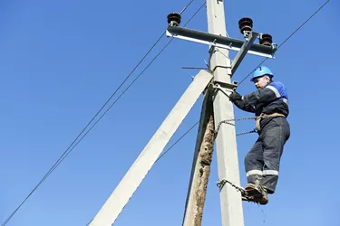 power electrician lineman at work on pole