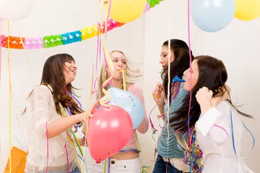 Birthday party celebration - four woman with confetti have fun