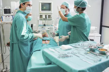 Surgeon operating the uncounscious patient in a surgery