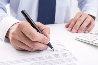 Businessman signing a document.