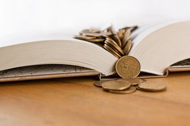 Open book with copper coins