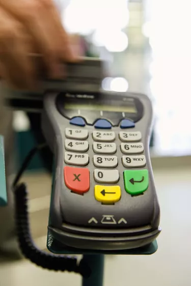 Hand scanning a credit card