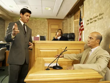 Side profile of a lawyer and a witness on the witness stand