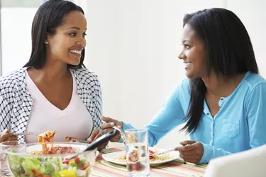 Two Women Eating Meal Together At Home