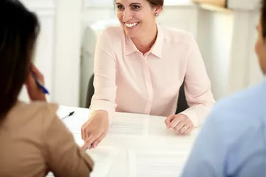 Female bank manager working on agreement contract