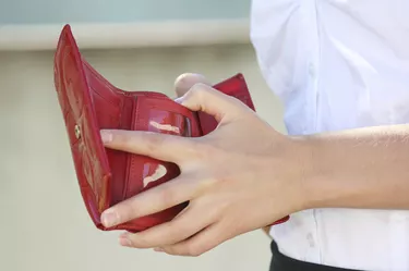 red leather wallet in female hands