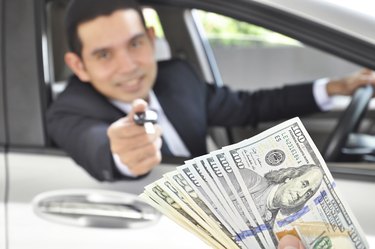 Man giving car key exchanging with money  - car pawn
