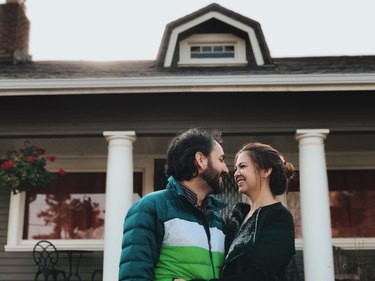 Newlyweds in front of a new house
