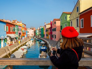Woman holding wallet on colorful canal