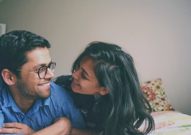 Adorable young couple smiling at each other