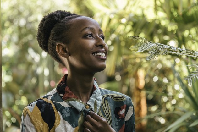 Portrait of happy young woman in a garden