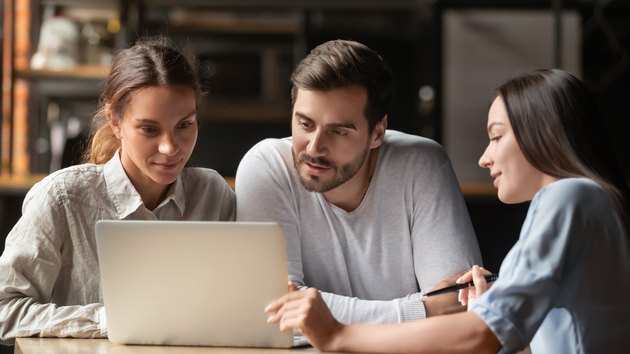 Female insurance mortgage broker consult couple showing online presentation