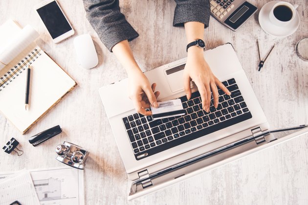 woman hand credit card with keyboard on table