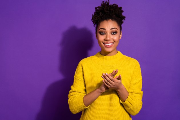 Portrait of positive cheerful lady enjoy applause isolated over purple violet background